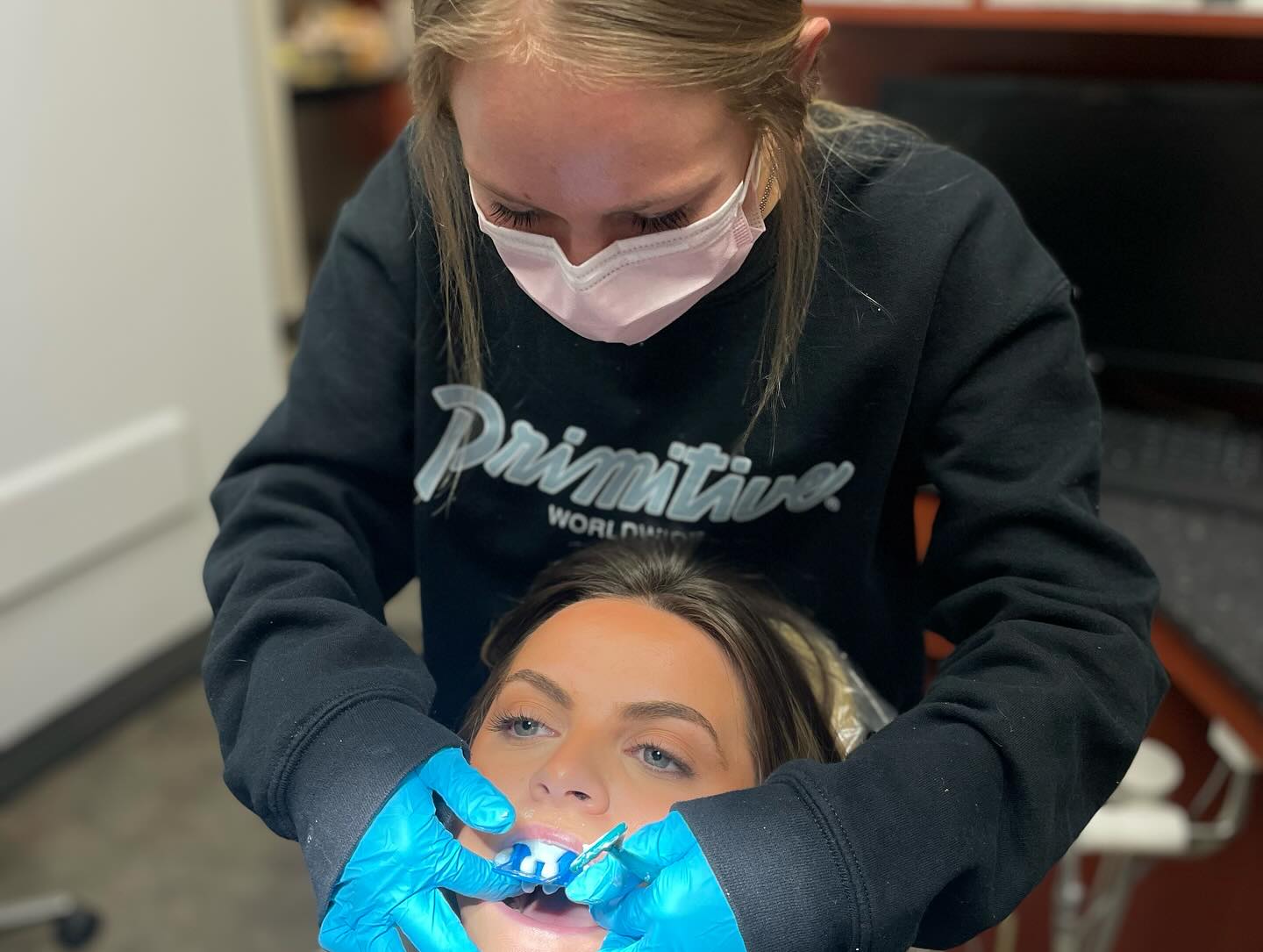 Illustrative chairside practice photo from First Class Dental Assisting